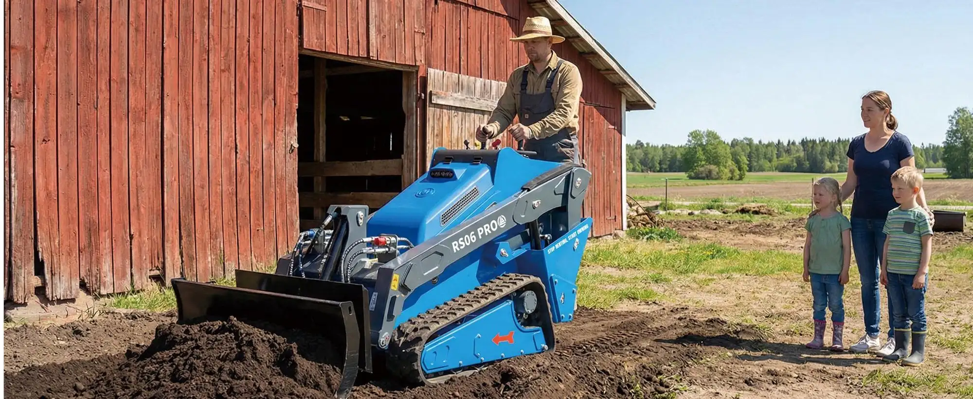 RIPPA RS06 PRO stand-on track loader pushing soil outside a red barn